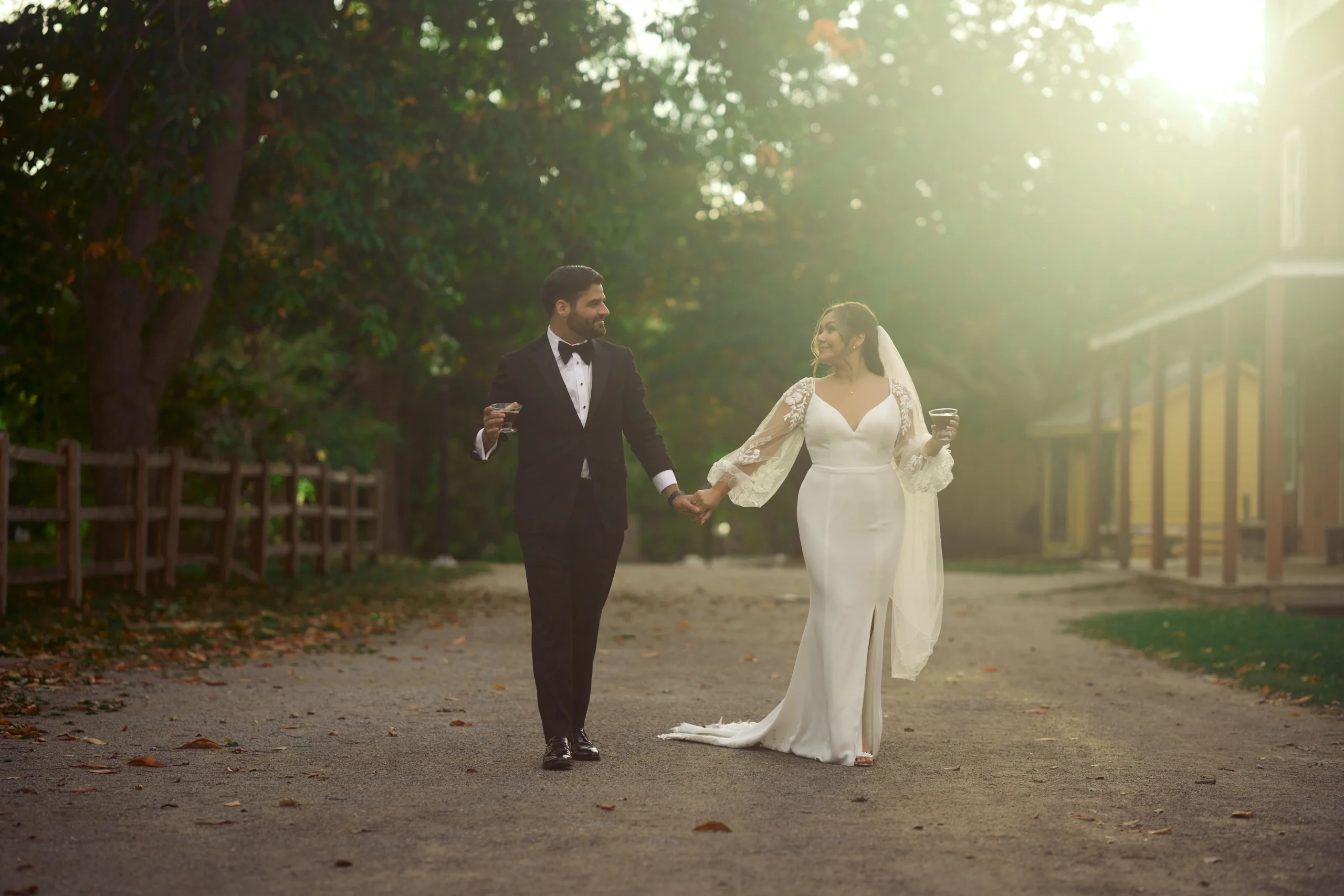 Bride and groom walking with cocktails