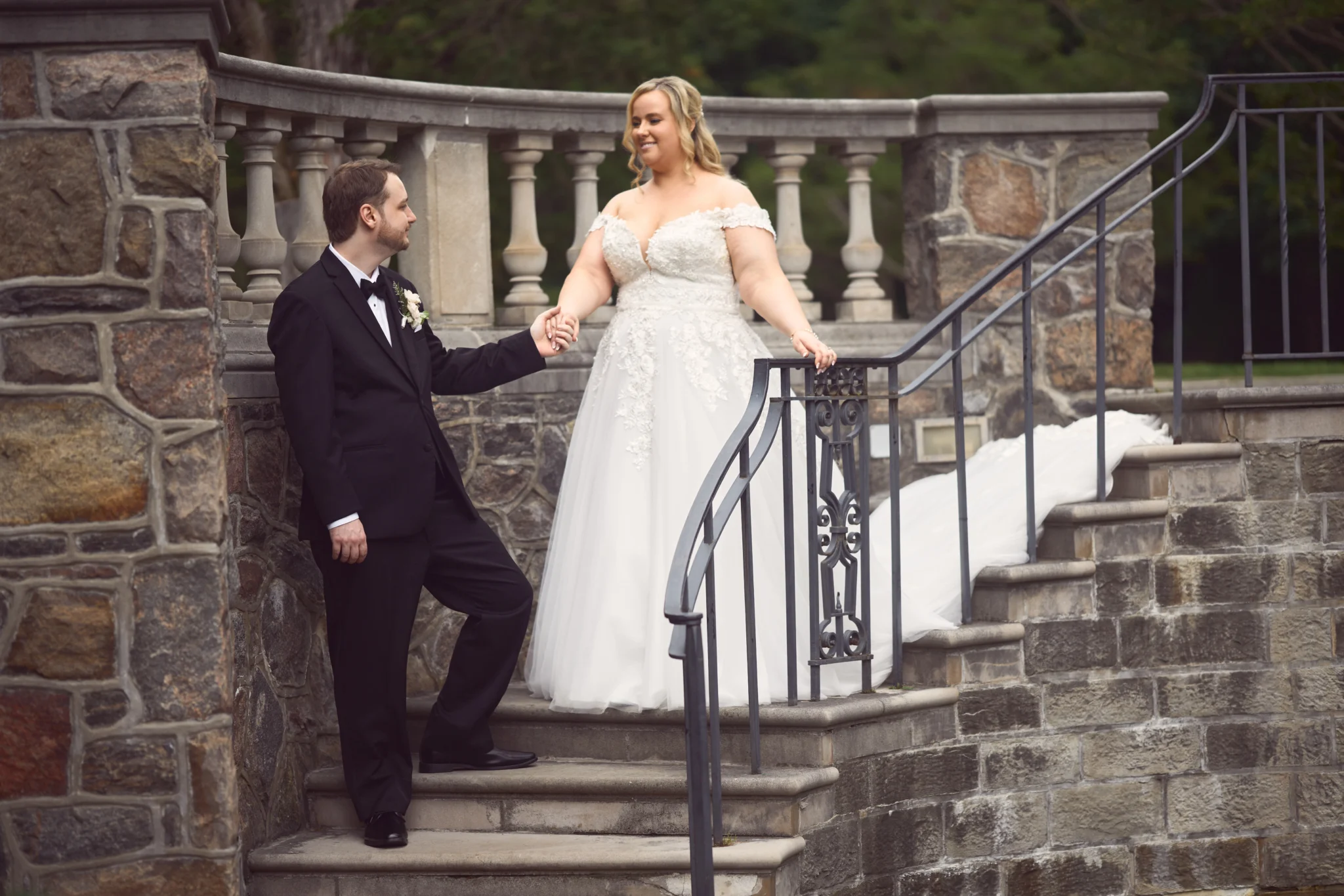 Groom walking bride down the stairs