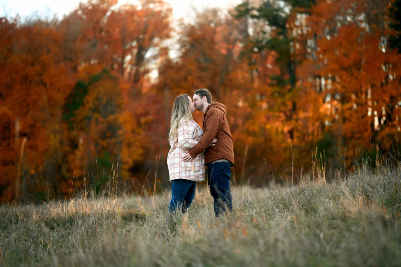 Guy and girl kissing in fall Scotsdale Farm Engagement Photoshoot