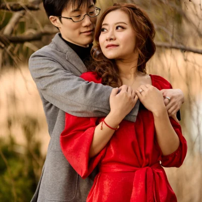 Guy holding girl in red dress Kariya Park Engagement Photoshoot