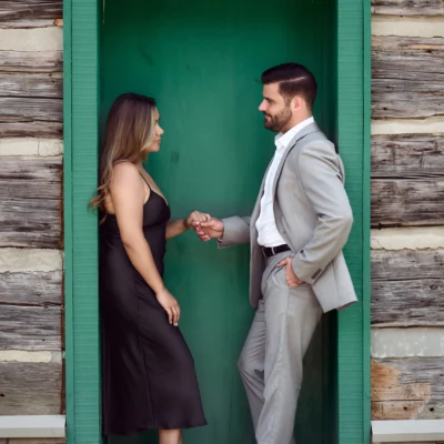 Man and woman next to a green door Black Creek Village Engagement Photoshoot
