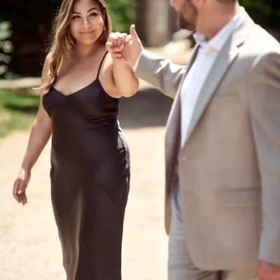Man walking with woman holding her hand Black Creek Village Engagement Photoshoot