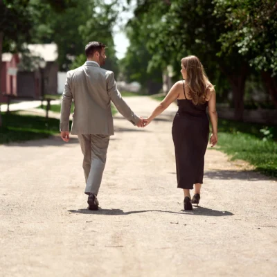 man and woman walking in the middle of the street Black Creek Village Engagement Photoshoot