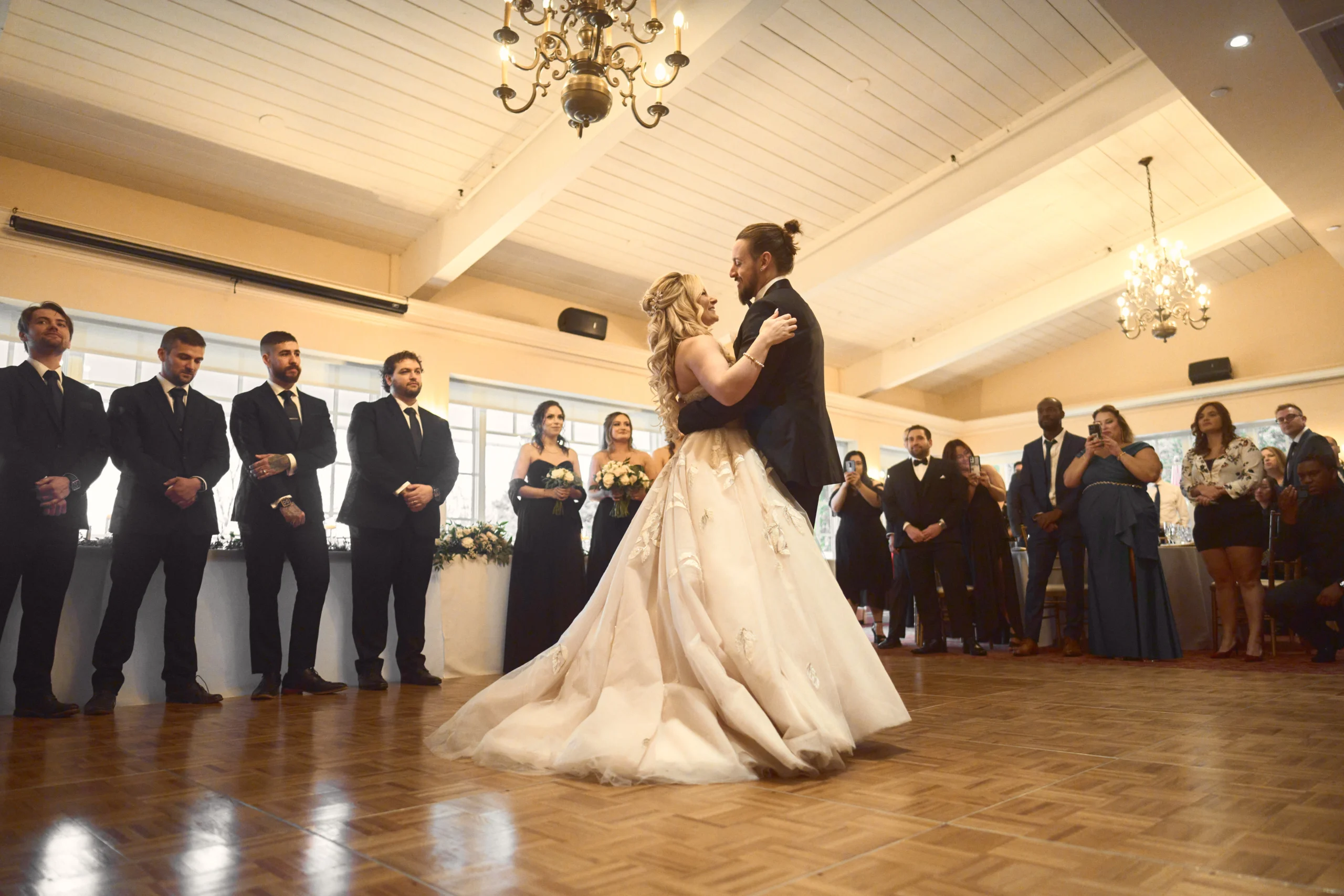 Bride and groom dancing indoors at the wedding venue
