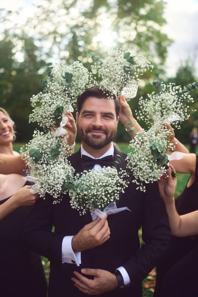 Groom with flowers in a wedding portrait setting