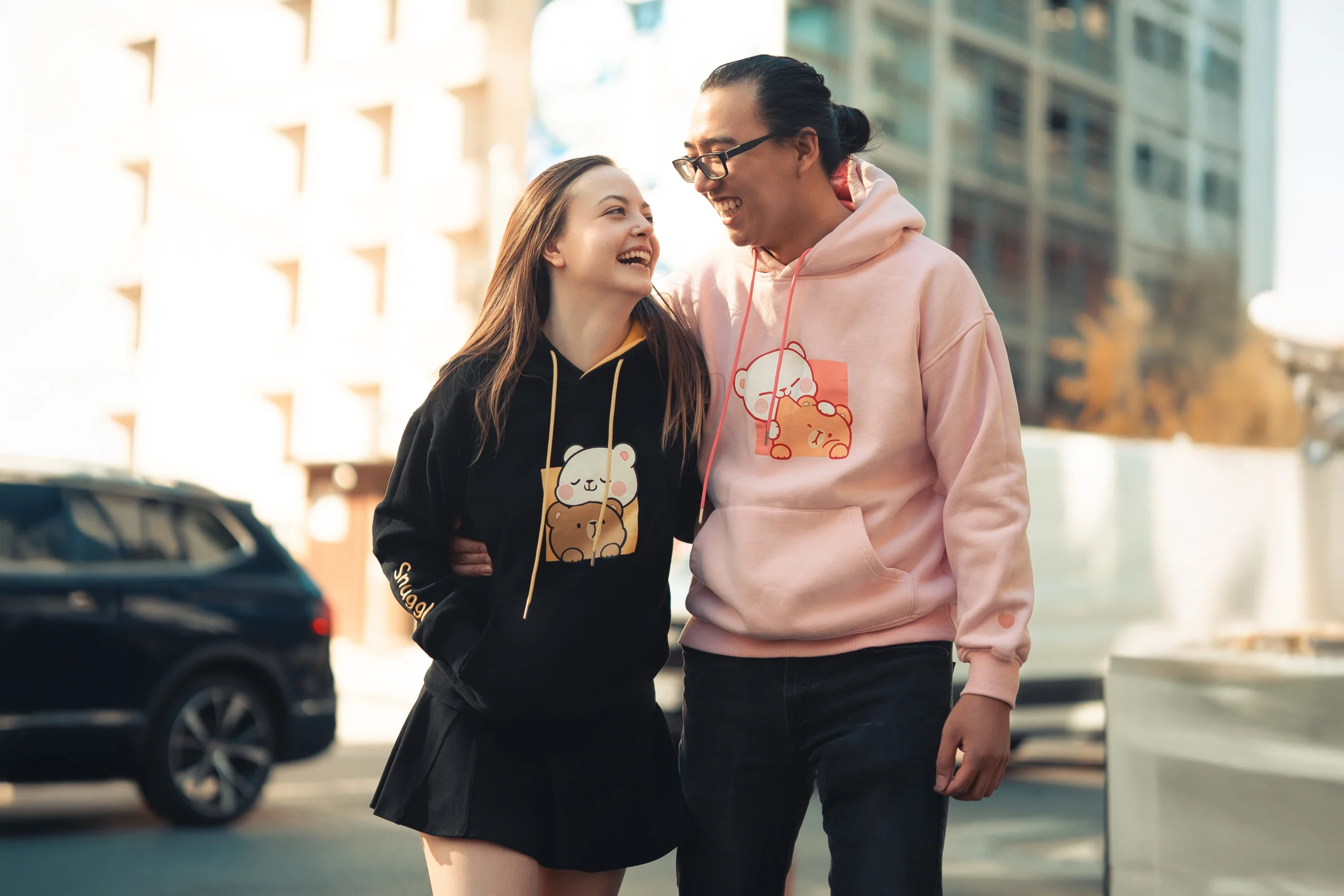 Toronto multicultural couple in anime hoodies walking on the streeet