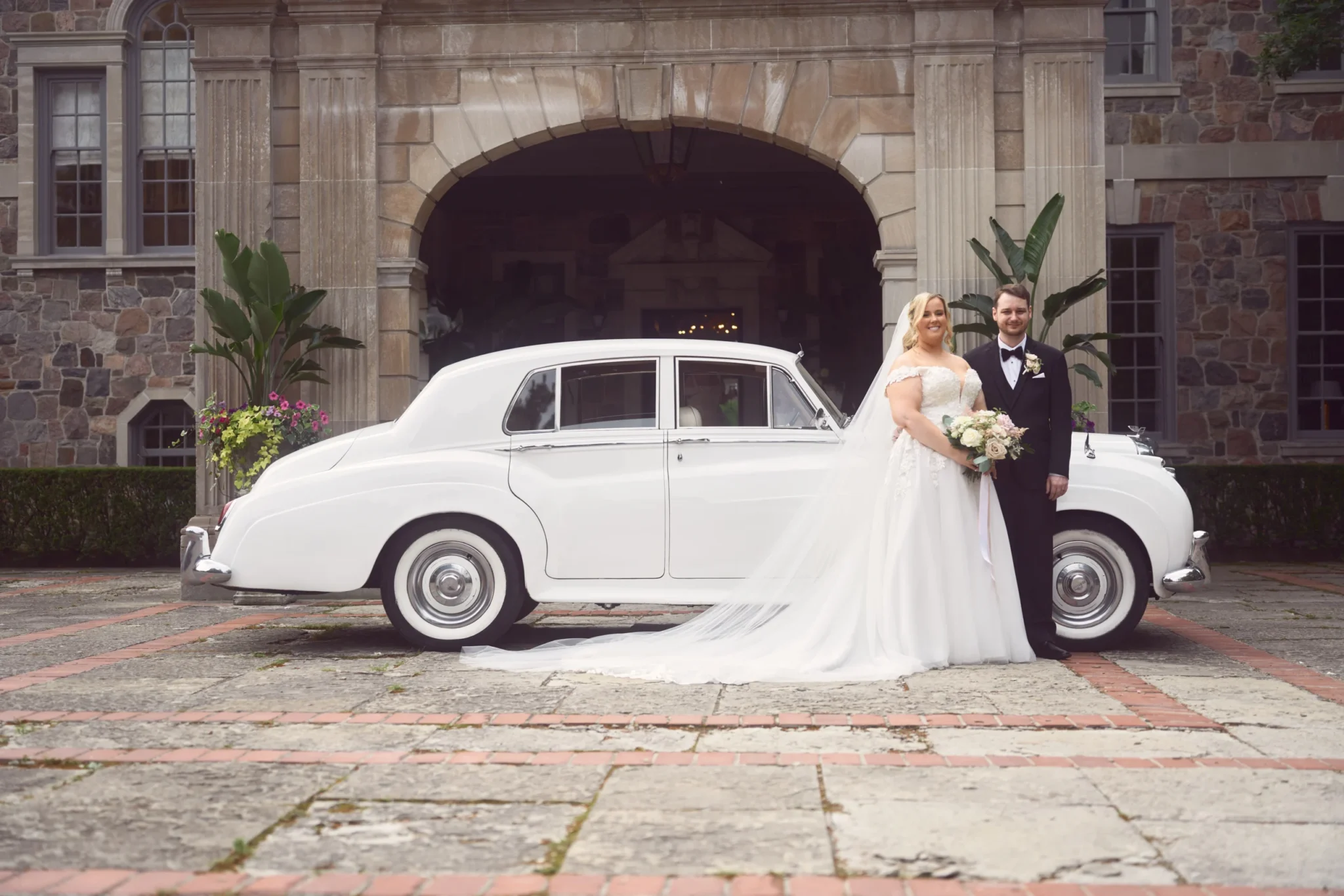 Bride-and-groom-next-to-vintage-car-1-scaled