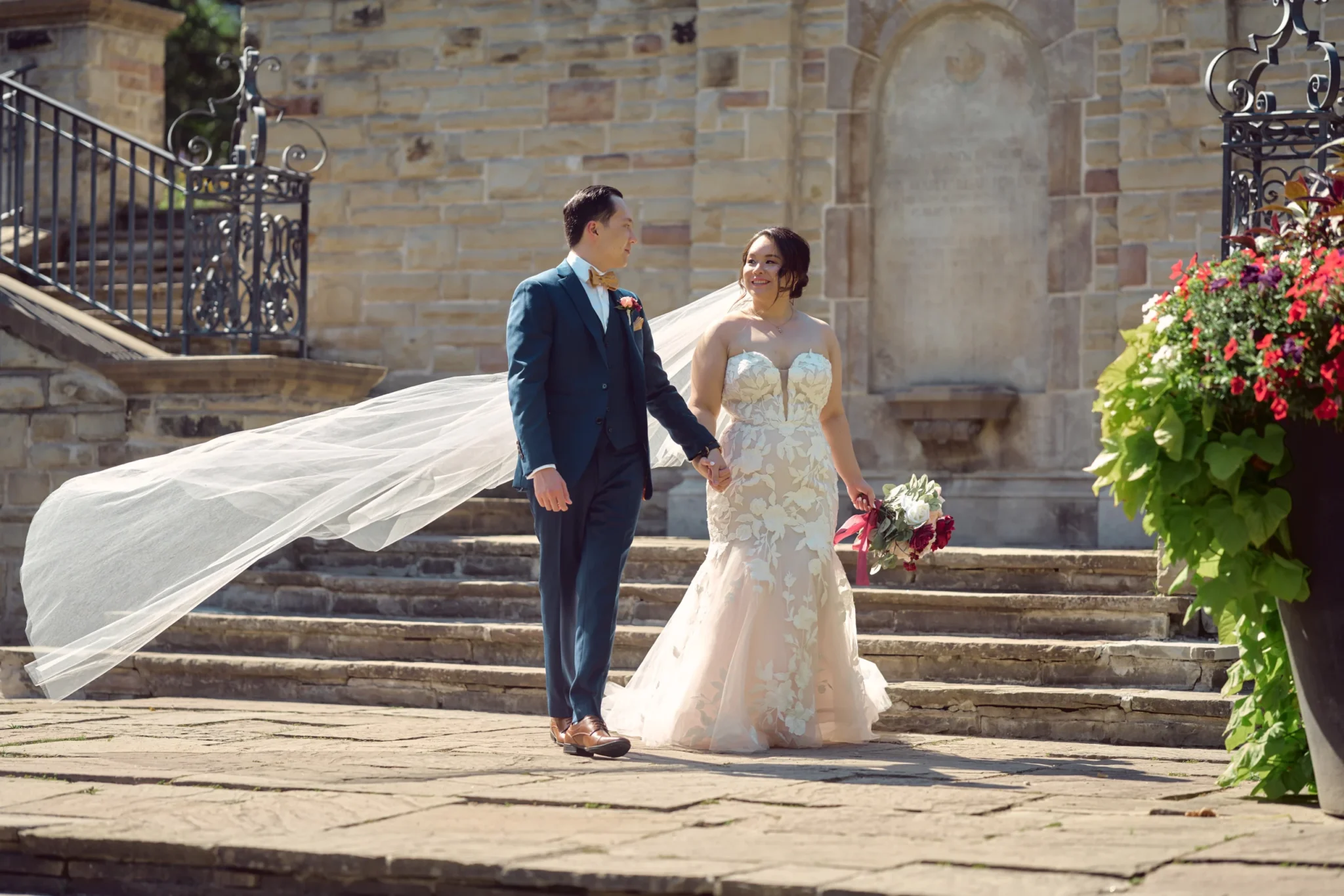 Groom-helping-Bride-down-the-stiars-scaled