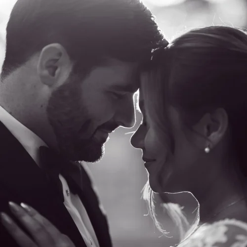 Black and white candid shot of bride and groom