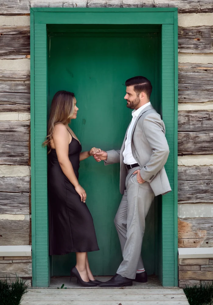 Man and woman next to a green door Black Creek Village Engagement Photoshoot